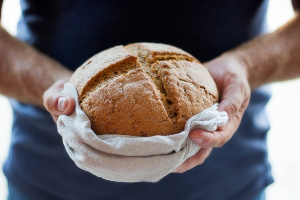 Man holding a loaf of bread