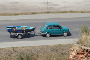 Car pulling a boat on the highway