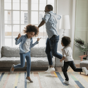 Family dancing in their living room