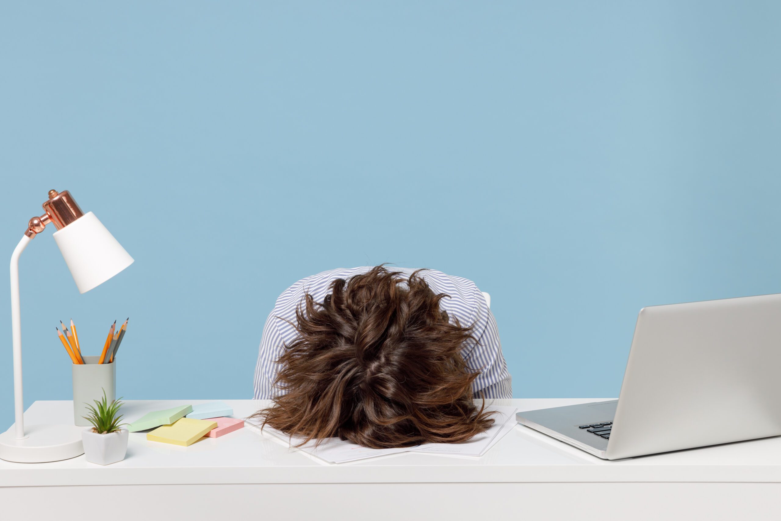 Frustrated Person with Head on Desk